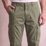 Men's Olive Relaxed Fit Cargo Trousers with Drawcord Hems, close-up of the waistband and front pocket.