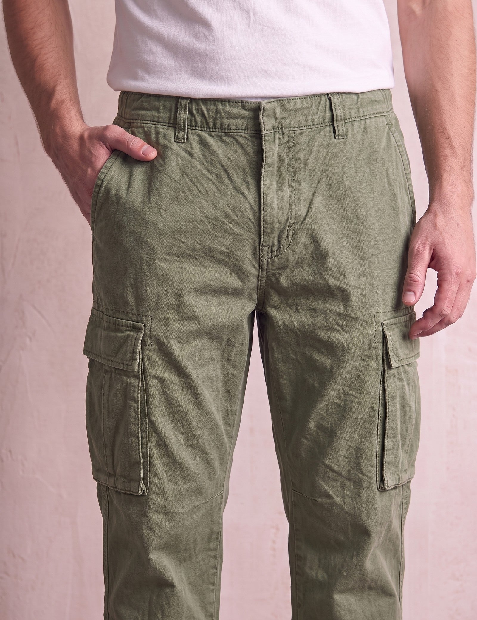 Men's Olive Relaxed Fit Cargo Trousers with Drawcord Hems, close-up of the waistband and front pocket.