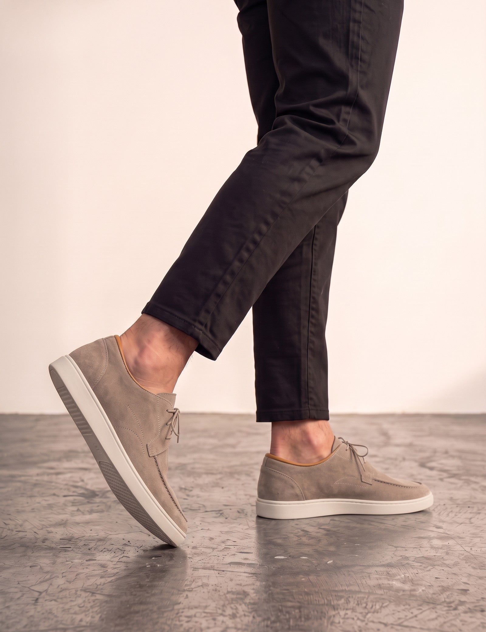 Men's Taupe Lace-Up Loafers with White Sole, the shoes in mid-step, showing the sole.