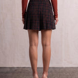 Women's Black and Red Tartan High Waisted Pleated Mini Skirt, back view from the waist down.