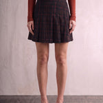 Women's Black and Red Tartan High Waisted Pleated Mini Skirt, front view from the waist down.