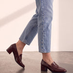 Women's Burgundy Patent Block Heel Loafers, the shoes in mid-step, showing the sole.