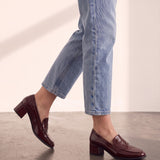 Women's Burgundy Patent Block Heel Loafers, the shoes in mid-step, showing the sole.