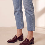 Women's Burgundy Patent Block Heel Loafers, three-quarter front view of the shoes, worn.