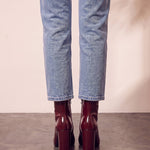 Women's Burgundy Patent Pointed Block Heel Ankle Boots, back view of the heels, worn.