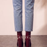 Women's Burgundy Patent Pointed Block Heel Ankle Boots, back view of the heels, worn.