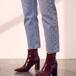 Women's Burgundy Patent Pointed Block Heel Ankle Boots, side view of the shoe, worn.