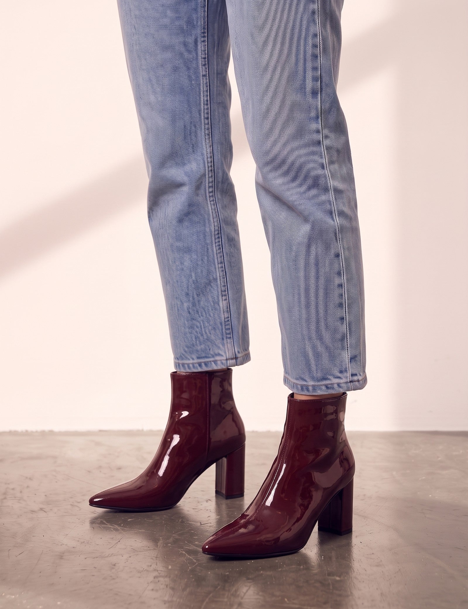 Women's Burgundy Patent Pointed Block Heel Ankle Boots, side view of the shoe, worn.