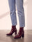 Women's Burgundy Patent Pointed Block Heel Ankle Boots, side view of the shoe, worn.