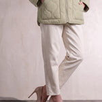 Women's Sage Green Quilted Collarless Jacket with Pockets, close-up of the upper body.