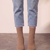 Women's Taupe Ribbed Knit Stiletto Sock Boots, front view of the shoes, worn.