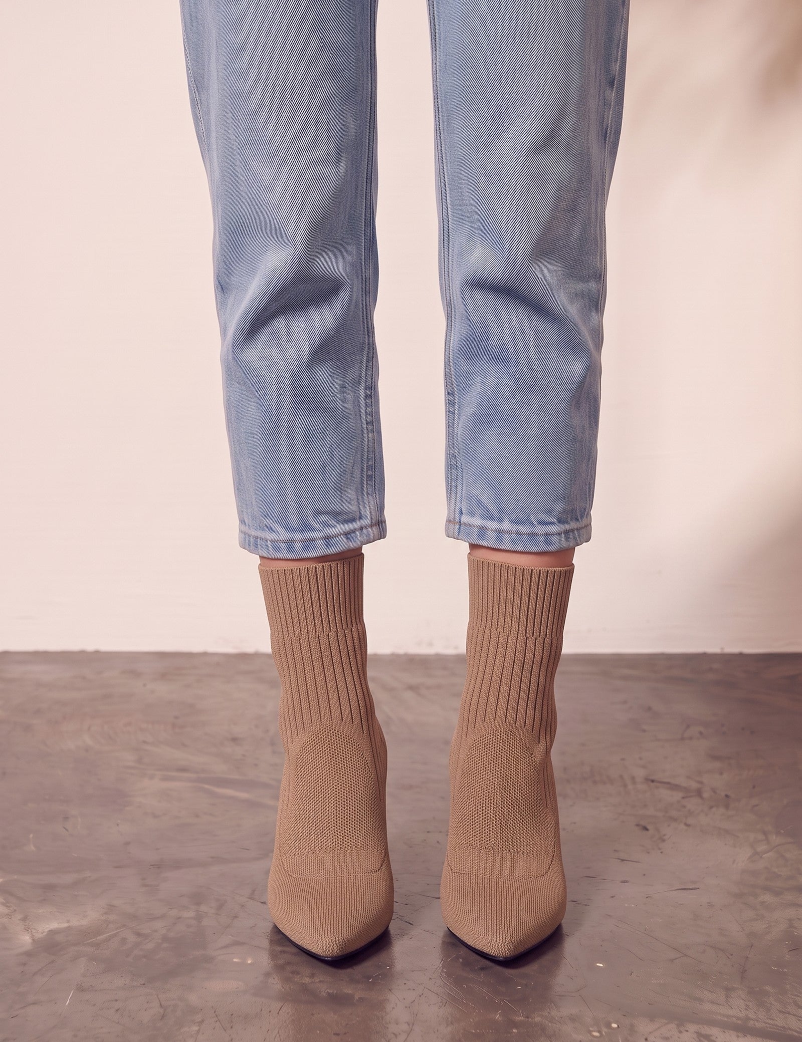 Women's Taupe Ribbed Knit Stiletto Sock Boots, front view of the shoes, worn.