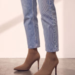 Women's Taupe Ribbed Knit Stiletto Sock Boots, side view of the shoe, worn.