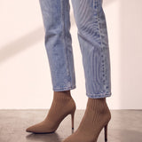 Women's Taupe Ribbed Knit Stiletto Sock Boots, side view of the shoe, worn.