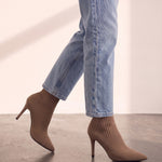 Women's Taupe Ribbed Knit Stiletto Sock Boots, the shoes in mid-step, showing the sole.