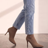 Women's Taupe Ribbed Knit Stiletto Sock Boots, the shoes in mid-step, showing the sole.