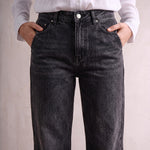 Women's Washed Black High Waisted Wide Leg Jeans, close-up of the waistband and front pocket.