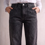 Women's Washed Black High Waisted Wide Leg Jeans, close-up of the waistband and front pocket.