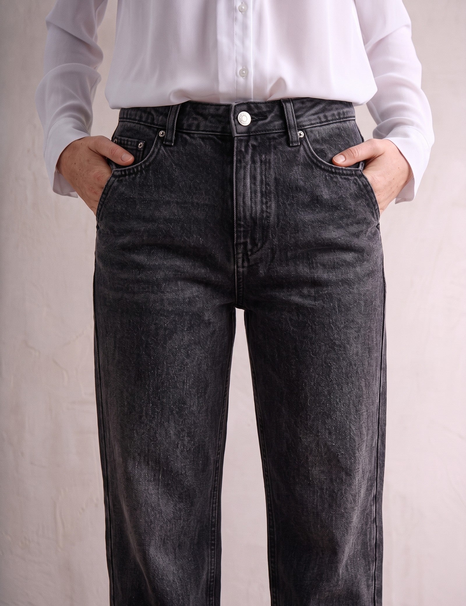 Women's Washed Black High Waisted Wide Leg Jeans, close-up of the waistband and front pocket.