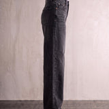 Women's Washed Black High Waisted Wide Leg Jeans, side view from the waist down.