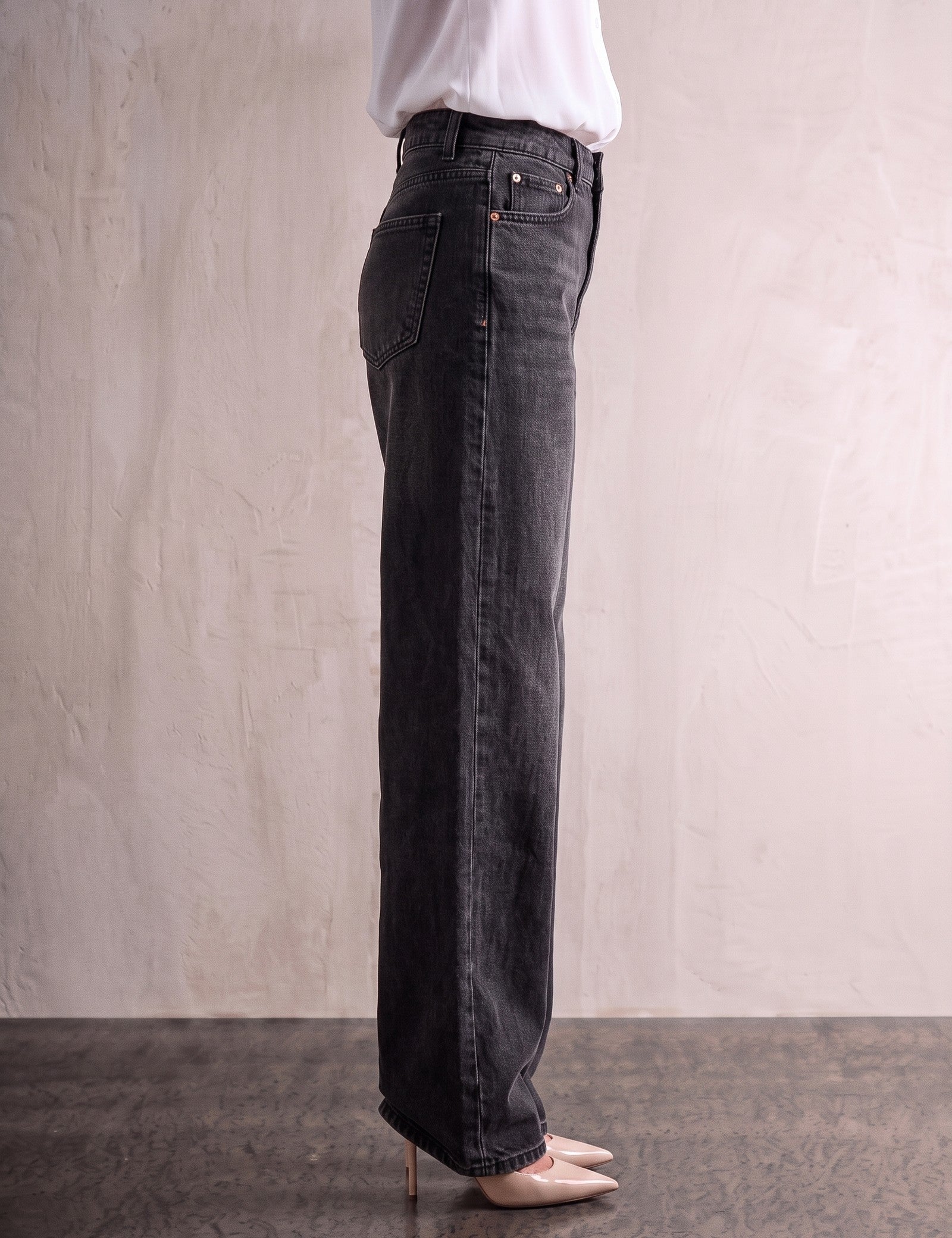 Women's Washed Black High Waisted Wide Leg Jeans, side view from the waist down.