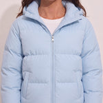Women's Baby Blue Hooded Puffer Jacket with Pockets, close-up of the upper body.