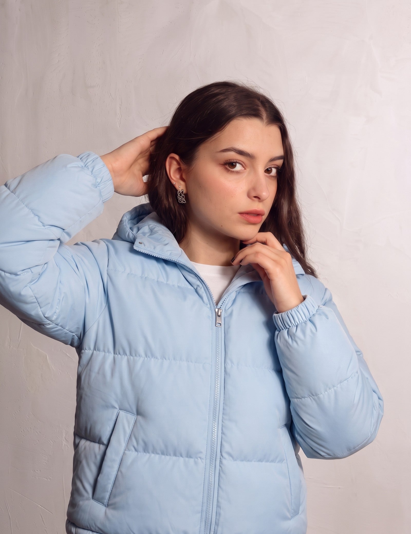 Women's Baby Blue Hooded Puffer Jacket with Pockets, close-up of the upper body.