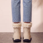 Women's Beige Faux Fur Lined Lace-Up Winter Boots, back view of the heels, worn.