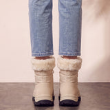 Women's Beige Faux Fur Lined Lace-Up Winter Boots, back view of the heels, worn.