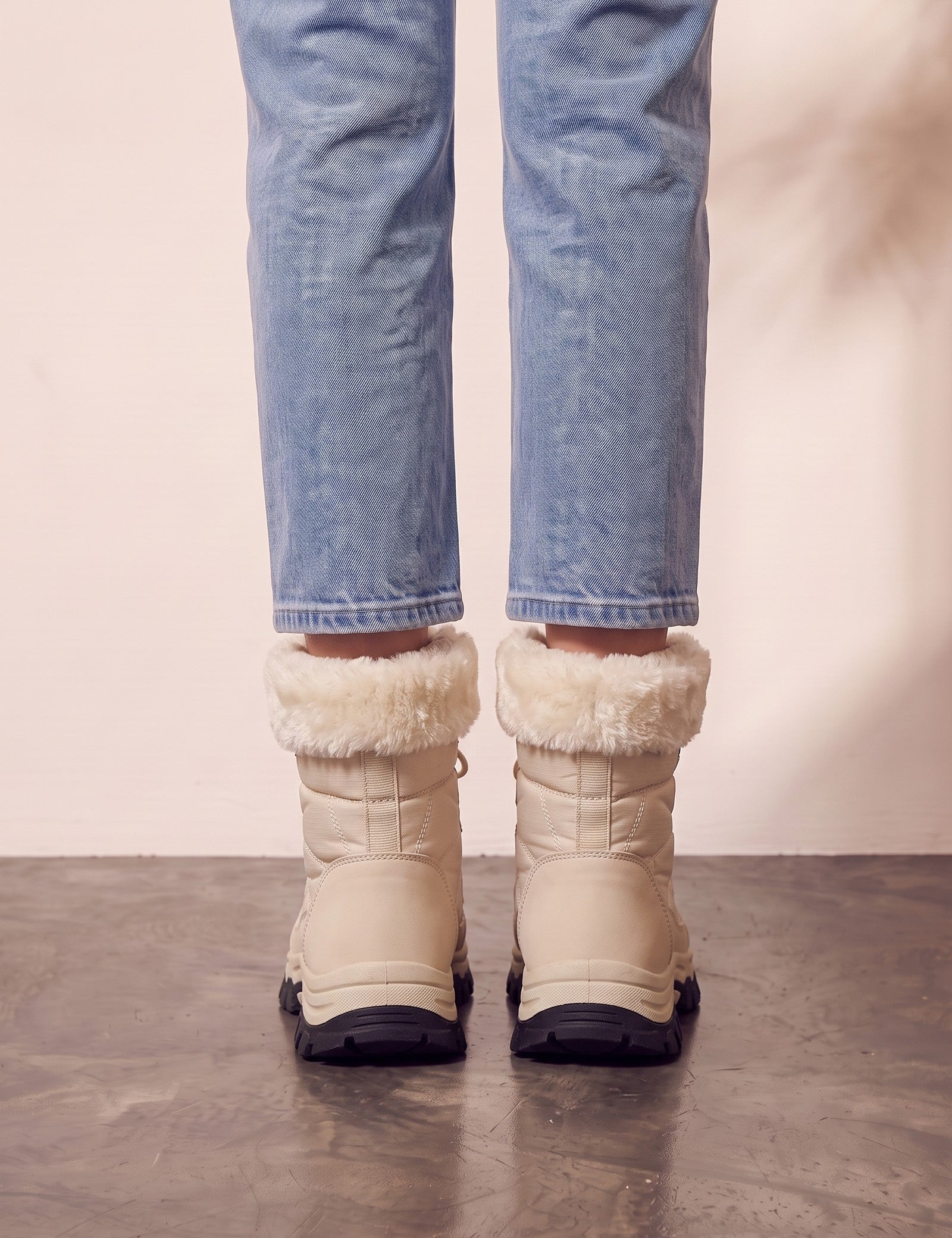 Women's Beige Faux Fur Lined Lace-Up Winter Boots, back view of the heels, worn.