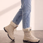 Women's Beige Faux Fur Lined Lace-Up Winter Boots, the shoes in mid-step, showing the sole.