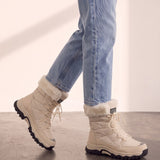 Women's Beige Faux Fur Lined Lace-Up Winter Boots, the shoes in mid-step, showing the sole.