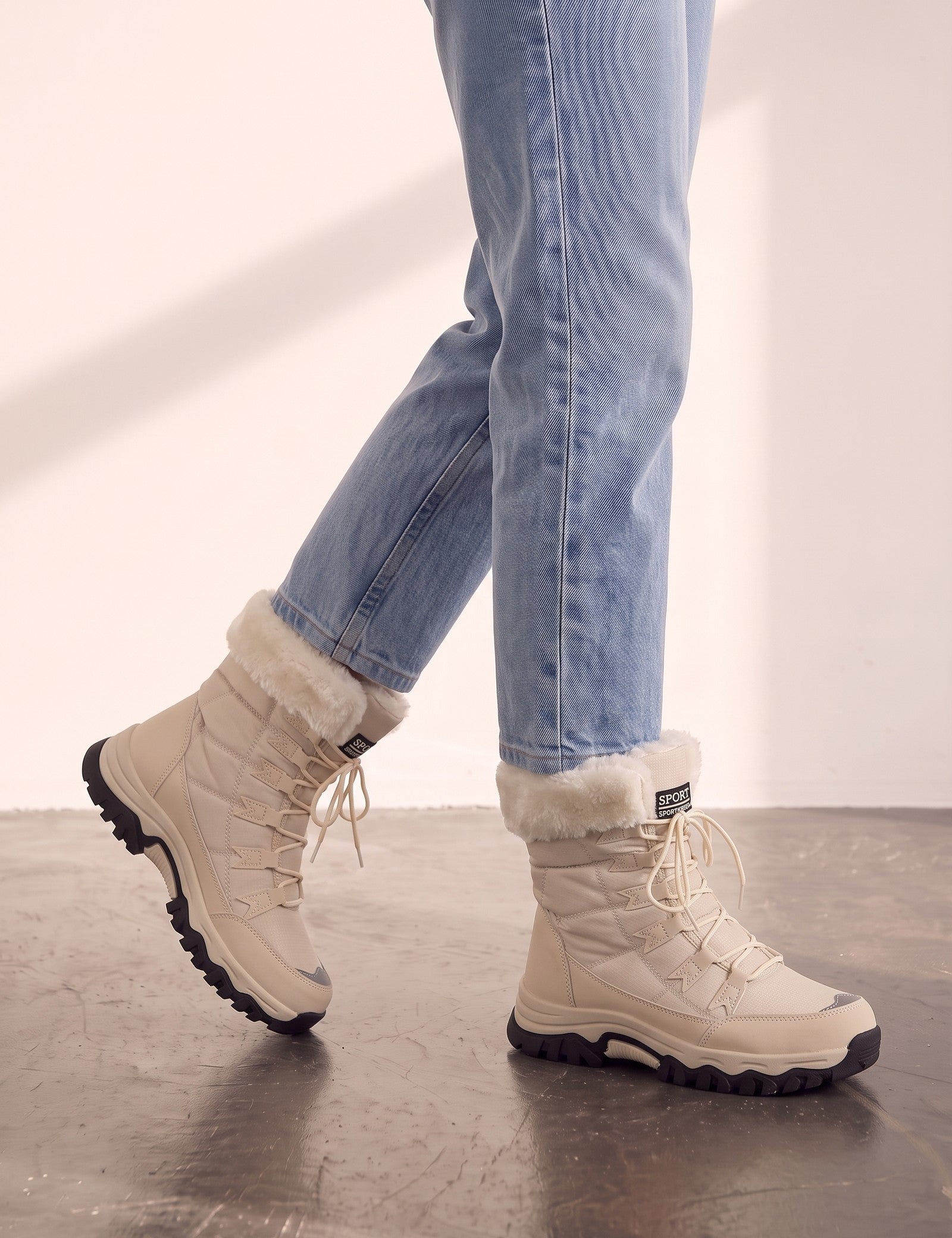Women's Beige Faux Fur Lined Lace-Up Winter Boots, the shoes in mid-step, showing the sole.