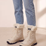 Women's Beige Faux Fur Lined Lace-Up Winter Boots, three-quarter front view of the shoes, worn.