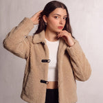 Women's Beige Teddy Jacket with Black Toggle Fastenings, close-up of the upper body.