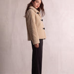 Women's Beige Teddy Jacket with Black Toggle Fastenings, side view, full length.