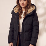 Women's Black Longline Quilted Winter Coat with Hood, three-quarter view from the left, full length.