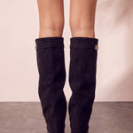 Women's Black Pointed-Toe Fold-Over Knee-High Boots, back view of the heels, worn.