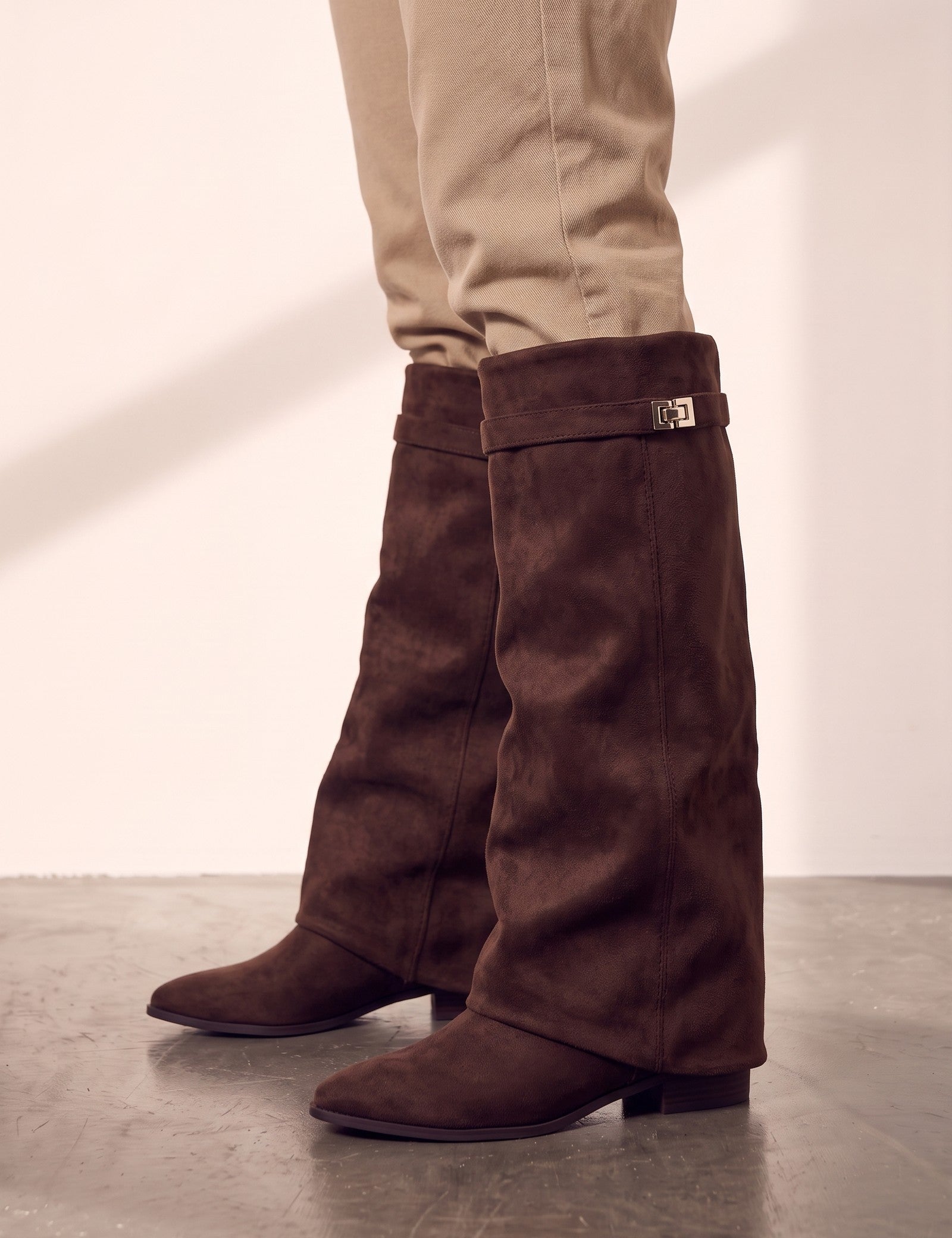 Women's Black Pointed-Toe Fold-Over Knee-High Boots - Brown, side view of the shoe, worn.