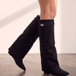 Women's Black Pointed-Toe Fold-Over Knee-High Boots, the shoes in mid-step, showing the sole.