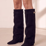 Women's Black Pointed-Toe Fold-Over Knee-High Boots, three-quarter front view of the shoes, worn.