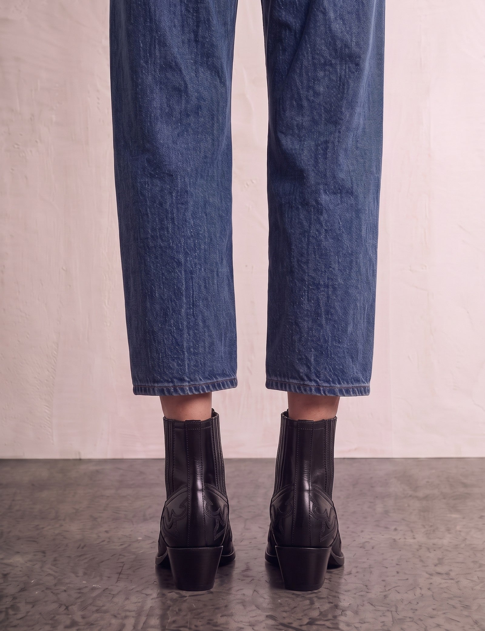 Women's Black Western Ankle Boots with Pointed Toe, back view of the heels, worn.