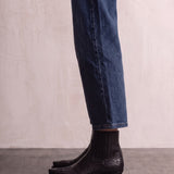 Women's Black Western Ankle Boots with Pointed Toe, side view of the shoe, worn.