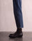 Women's Black Western Ankle Boots with Pointed Toe, side view of the shoe, worn.