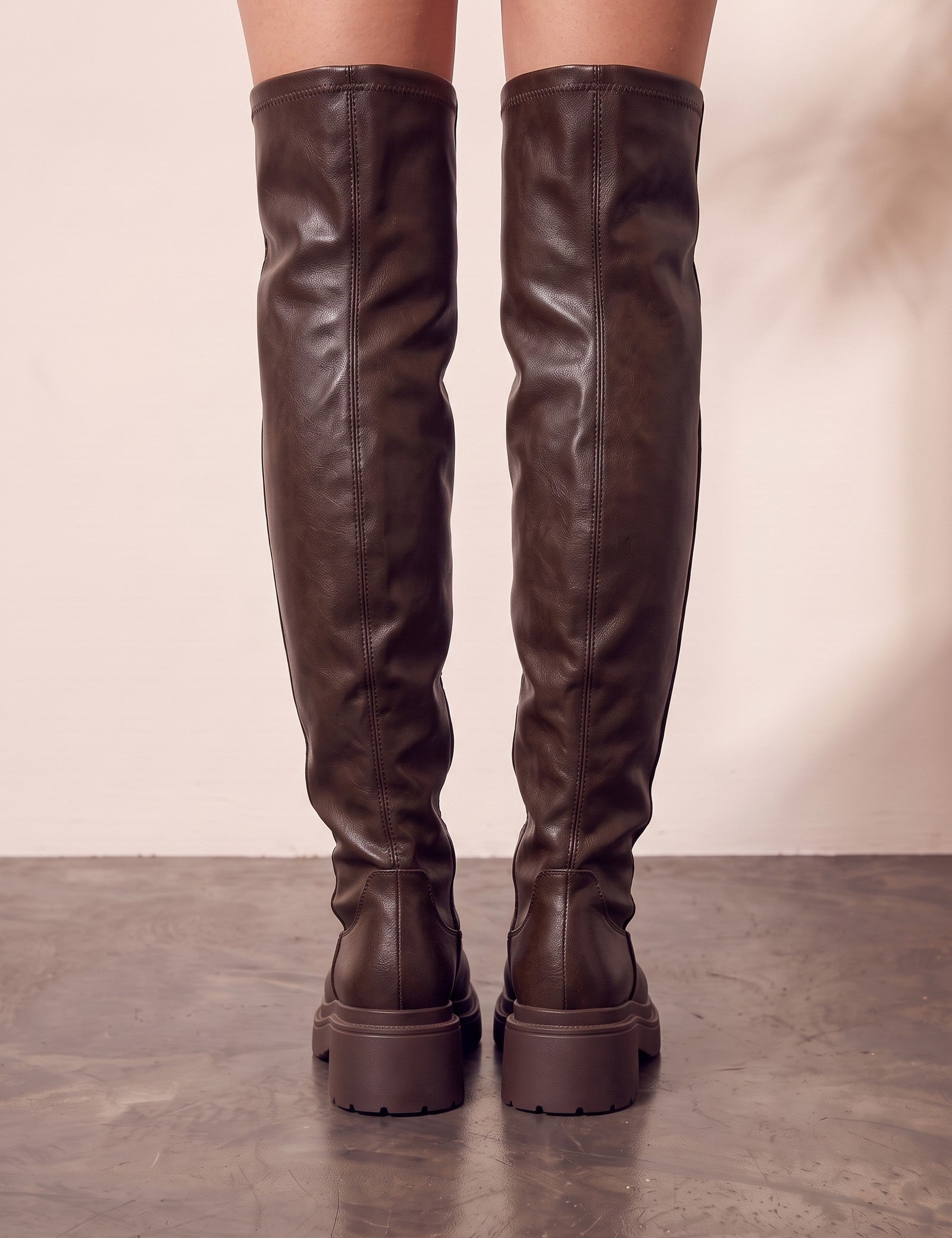 Women's Brown Leather-Look Platform Over-the-Knee Boots, back view of the heels, worn.