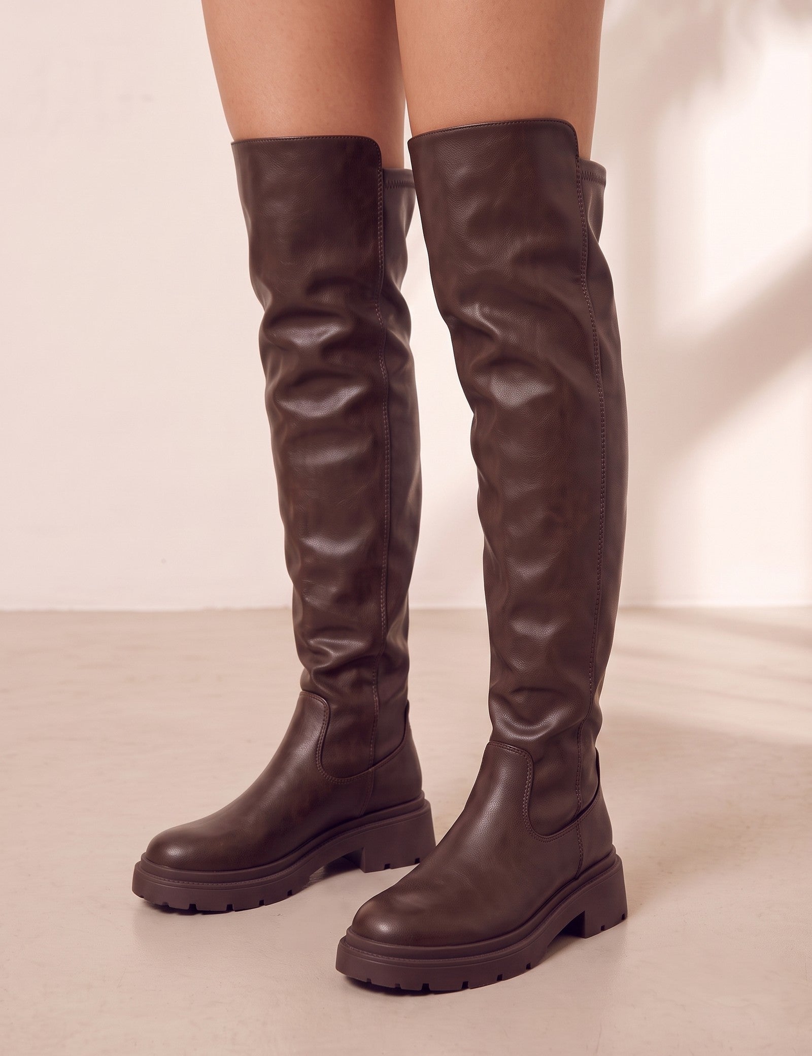 Women's Brown Leather-Look Platform Over-the-Knee Boots, three-quarter front view of the shoes, worn.