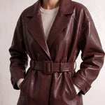 Women's Burgundy Belted Leather-Look Jacket with Lapels, close-up of the upper body.
