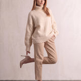 Women's Cream Relaxed Fit Roll Neck Jumper, three-quarter view from the left, full length.