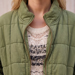 Women's Green Relaxed Fit Quilted Jacket with Pockets, close-up of the upper body.