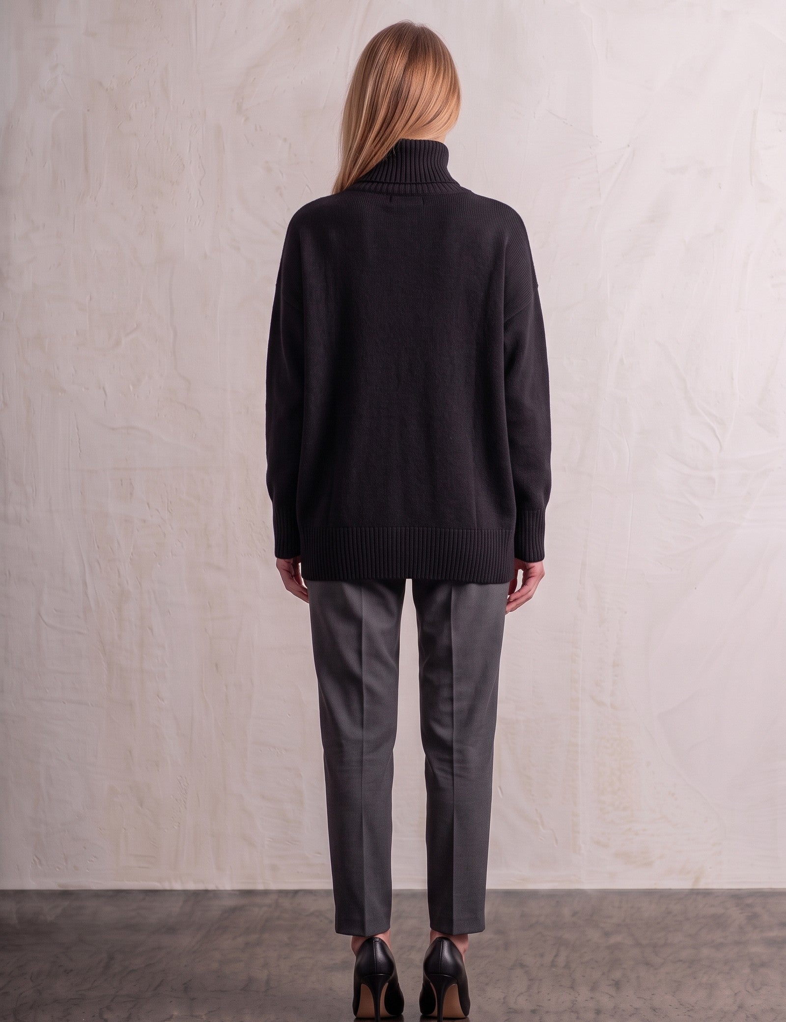 Women's Relaxed Fit Roll Neck Jumper in Black, back view, full length.